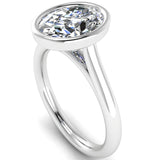 Harrogate Jewellers' ELARA Engagement Ring featuring a lab-grown oval cut diamond, bezel set on a platinum band, perfect for bespoke jewellery lovers in Yorkshire.