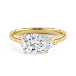 A pear-cut diamond engagement ring with a yellow gold band, shown on a clean white background.
