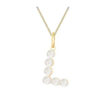 Gold necklace with a pendant featuring pearls on a white background