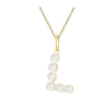 Gold necklace with a pendant featuring pearls on a white background