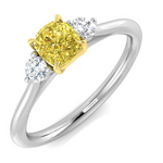 Diamond ring with a yellow center stone and two smaller white stones on a white background