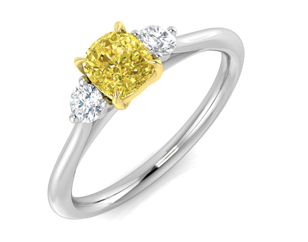 Diamond ring with a yellow center stone and two smaller white stones on a white background