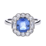 Ring with a sapphire gemstone and diamond accents on a white background art deco inspired sapphire engagement ring 