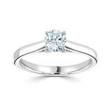 Harrogate Jewellers classic cross-over solitaire engagement ring with a round brilliant cut diamond, set in platinum, on a white background. Earth mined diamond certified by GIA.