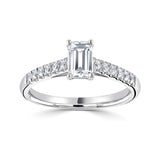 Harrogate Jewellers' Tapered Claw Set Emerald Cut Diamond Engagement Ring, featuring a central earth-mined diamond, accentuated with a row of smaller diamonds in a platinum band.