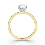 Harrogate Jewellers' Round Brilliant Cut Diamond Engagement Ring with Grain Set Shoulders, featuring a central Earth Mined Diamond and smaller side stones on a white gold band, displayed on a white background.