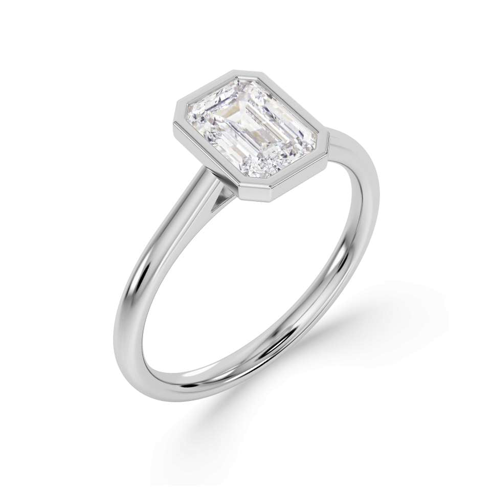 Bezel Set Emerald Cut Solitaire Diamond Engagement Ring by Harrogate Jewellers. Elegant platinum band with a stunning, earth mined diamond. Bespoke jewellery design in Harrogate, Yorkshire.