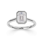 Bezel set emerald cut solitaire diamond engagement ring by Harrogate Jewellers. The ring features a premium quality, earth-mined diamond, expertly set in platinum. Yorkshire bespoke jewellery design.