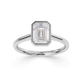 Bezel set emerald cut solitaire diamond engagement ring by Harrogate Jewellers. The ring features a premium quality, earth-mined diamond, expertly set in platinum. Yorkshire bespoke jewellery design.
