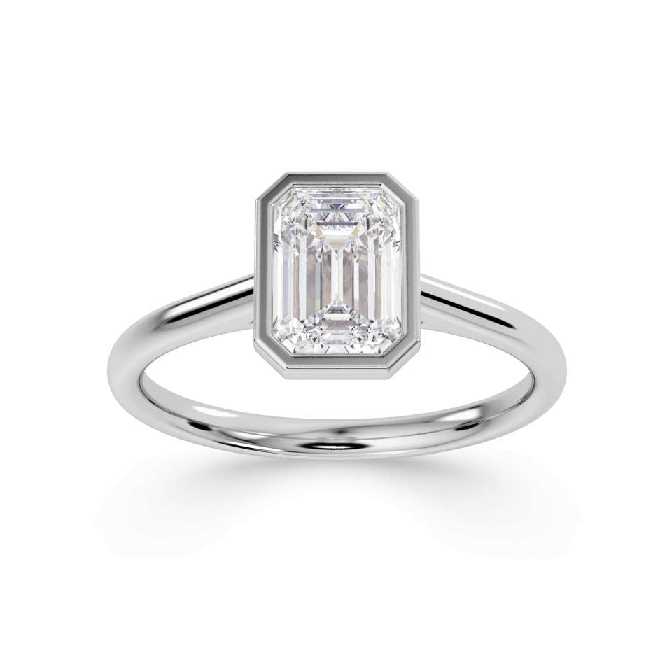 Bezel set emerald cut solitaire diamond engagement ring by Harrogate Jewellers. The ring features a premium quality, earth-mined diamond, expertly set in platinum. Yorkshire bespoke jewellery design.