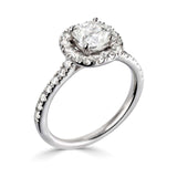 Cushion Cut Diamond Halo Shoulder Set Engagement Ring from Harrogate Jewellers, featuring a large center diamond surrounded by smaller stones on a silver band