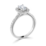 Harrogate Jewellers Emerald Cut Diamond Halo Shoulder Set Engagement Ring, featuring a large Earth Mined Diamond, surrounded by a halo of smaller diamonds on a platinum band.