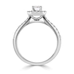 Emerald Cut Diamond Halo Shoulder Set Engagement Ring by Harrogate Jewellers, featuring a central emerald-cut diamond encircled by smaller stones on a platinum band, against a white background.
